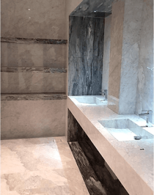 Flooring & vanity in bianco gioia with border in blue lagoon